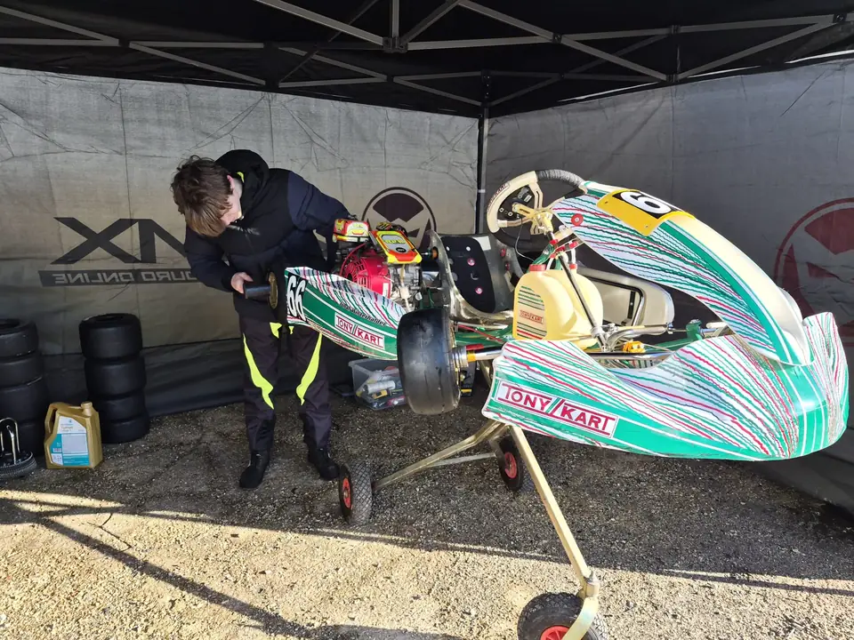 Jonah working on his Tony Kart in the pit tent